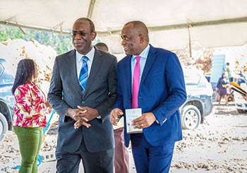 Dr. Michael Lawerence, a Director at Oriental Developers (Caribbean) Ltd. and Hon. Roosevelt Skerrit, PM of Dominica exchange a quite joke will entering the groundbreaking ceremony